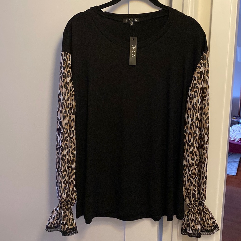 Knit top with chiffon sleeves and lace trim.